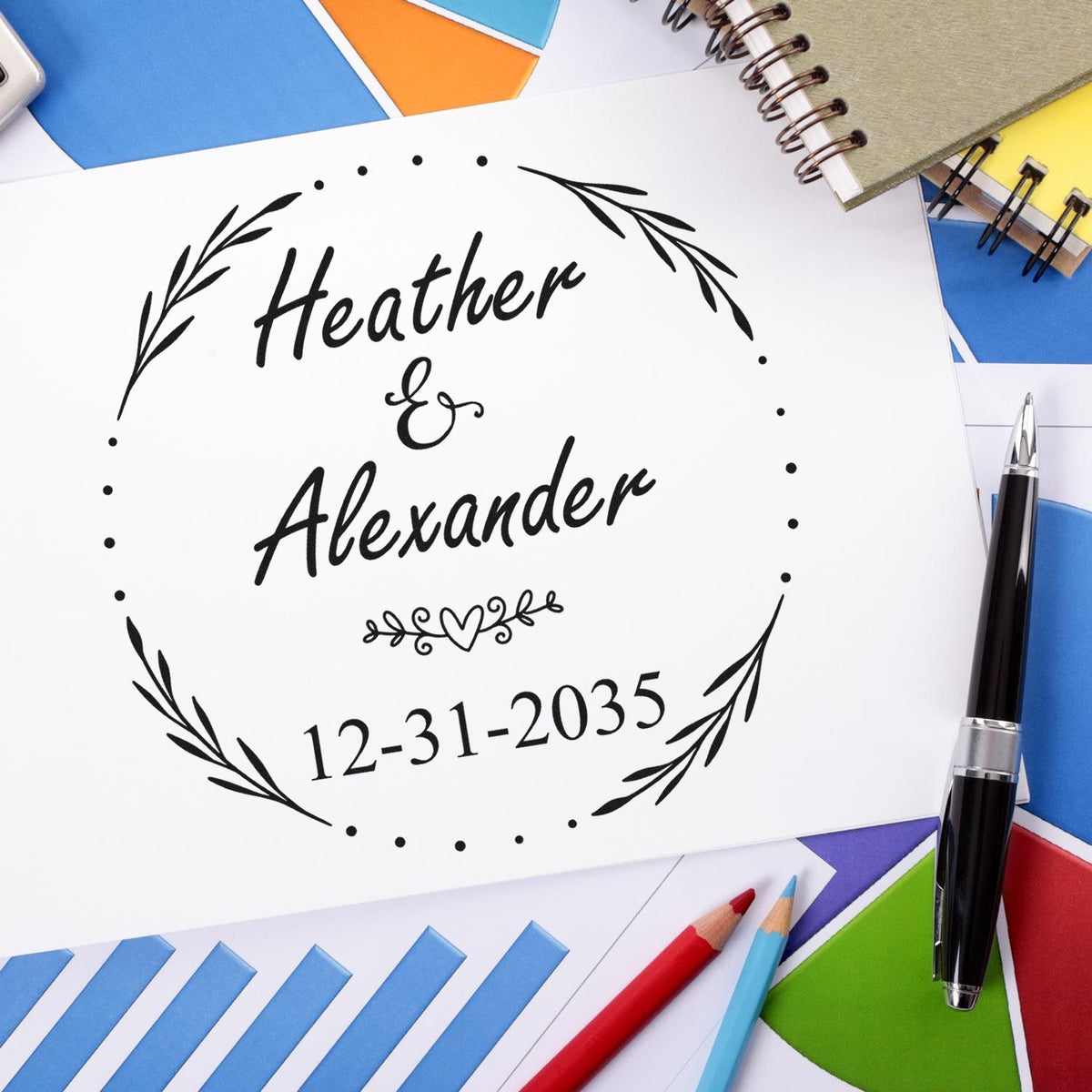 Custom black stamp and seal for Heather & Alexander with floral wreath and date on white paper, surrounded by colorful stationery