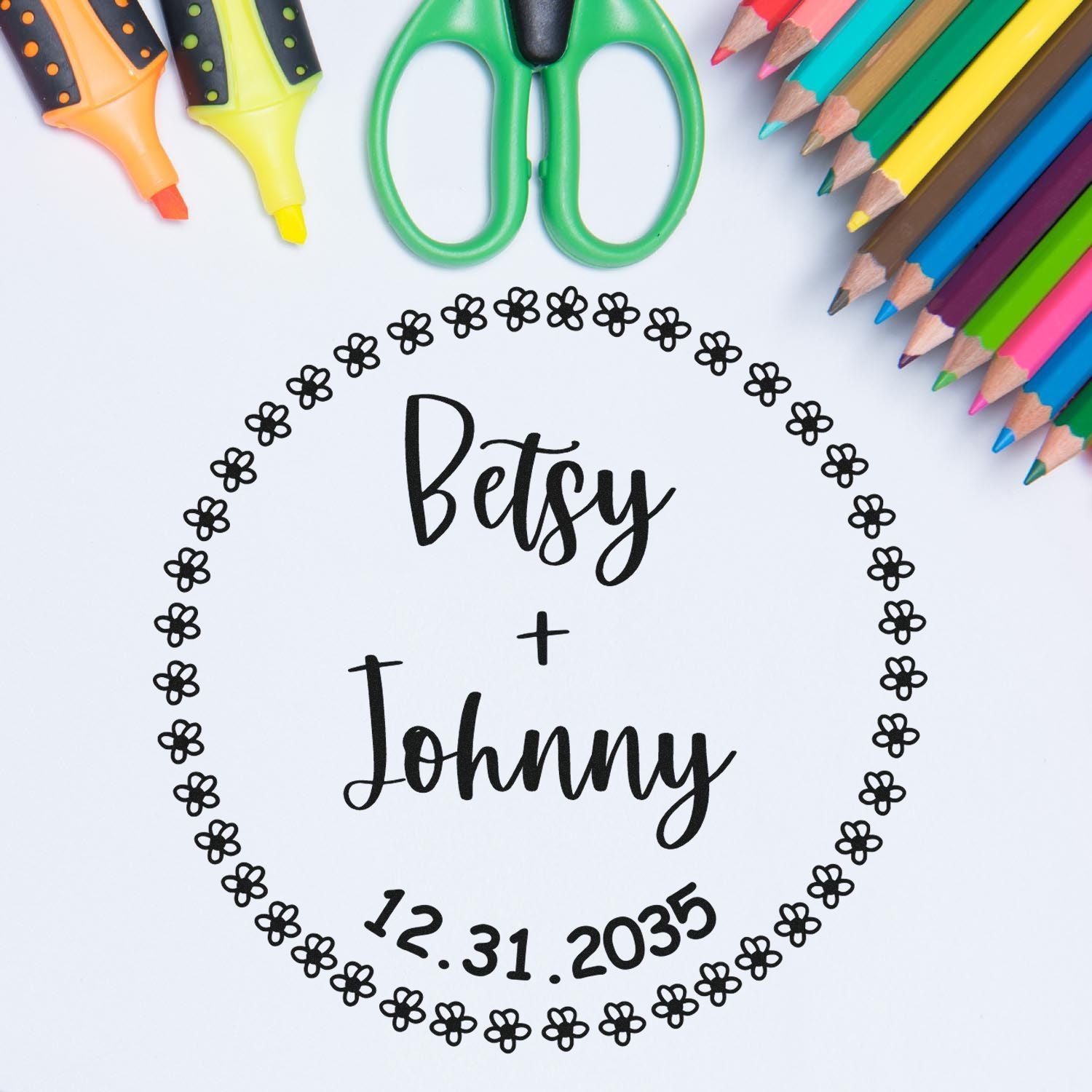 Custom floral wedding stamp and seal reading Betsy + Johnny 12.31.2035, with colorful pencils, scissors and markers.