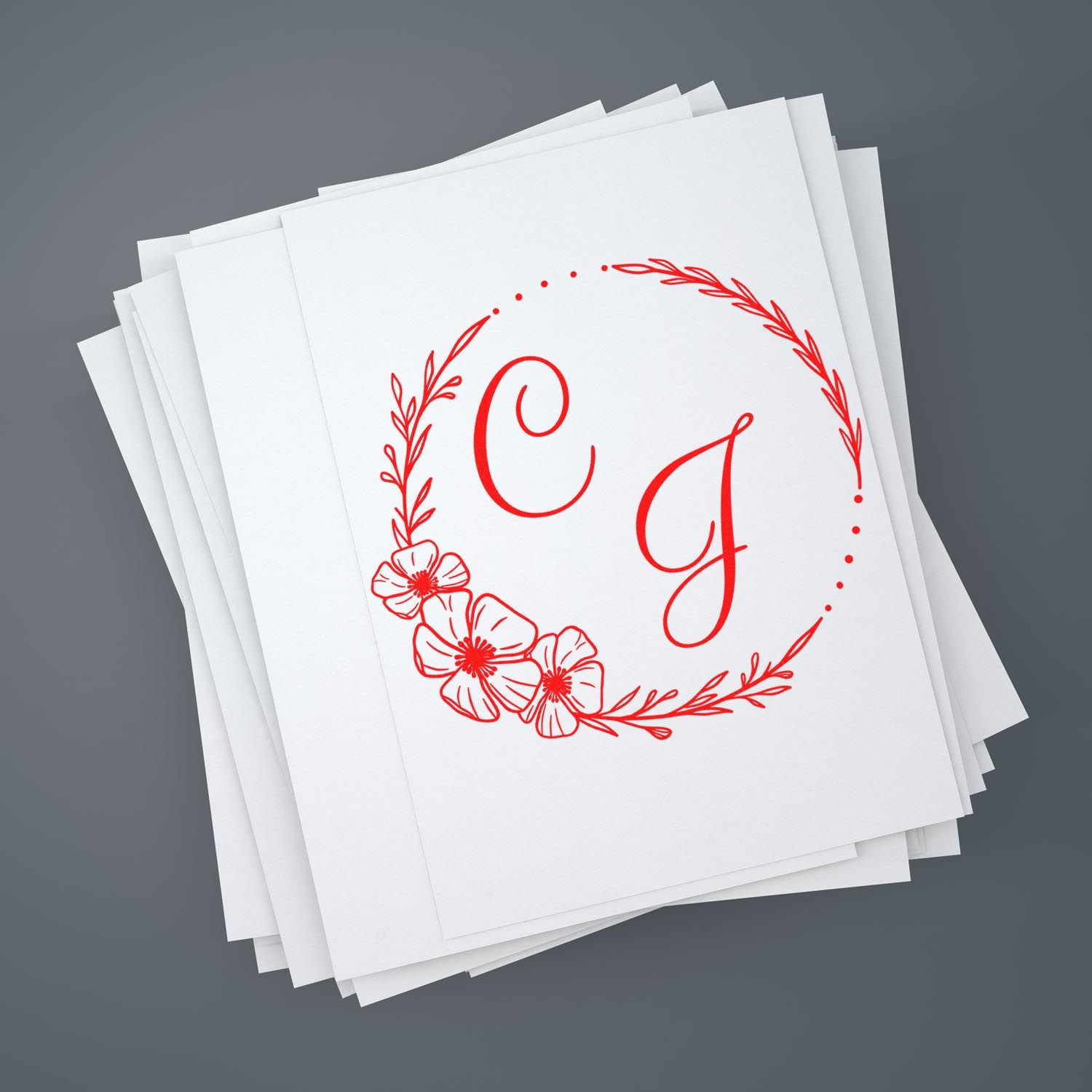 Stack of white stamp cards with a red floral monogram seal featuring letters C and J on a gray background.