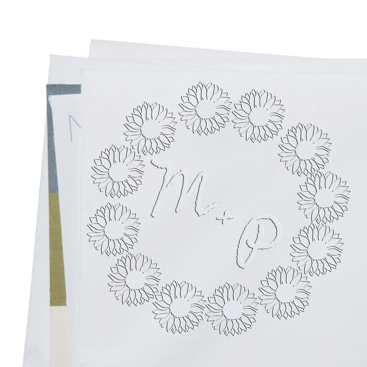 White embossed stamp and seal samples with floral sunflower wreath, Mr. & P monogram, and pastel paper swatches.