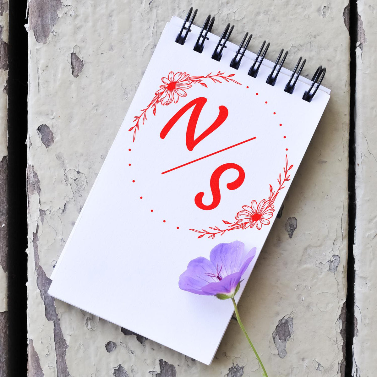 ESS Round Flowered Initials Bliss handmade couples' wedding stamp in use, featuring floral design and personalized initials.