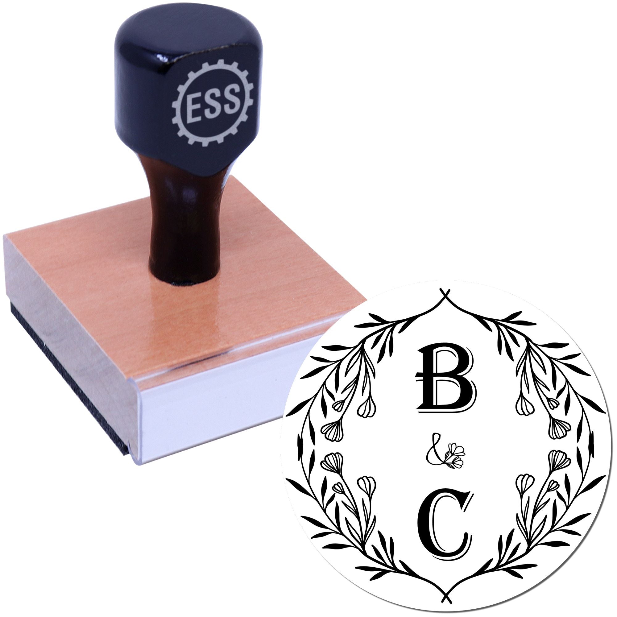 Black embossing stamp on rosewood base with circular floral seal design featuring monogram B and C.