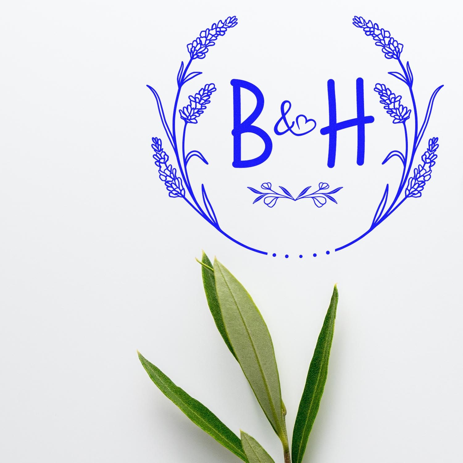 Blue floral stamp seal with B&H monogram and heart, lavender wreath, on white background with green leaves.