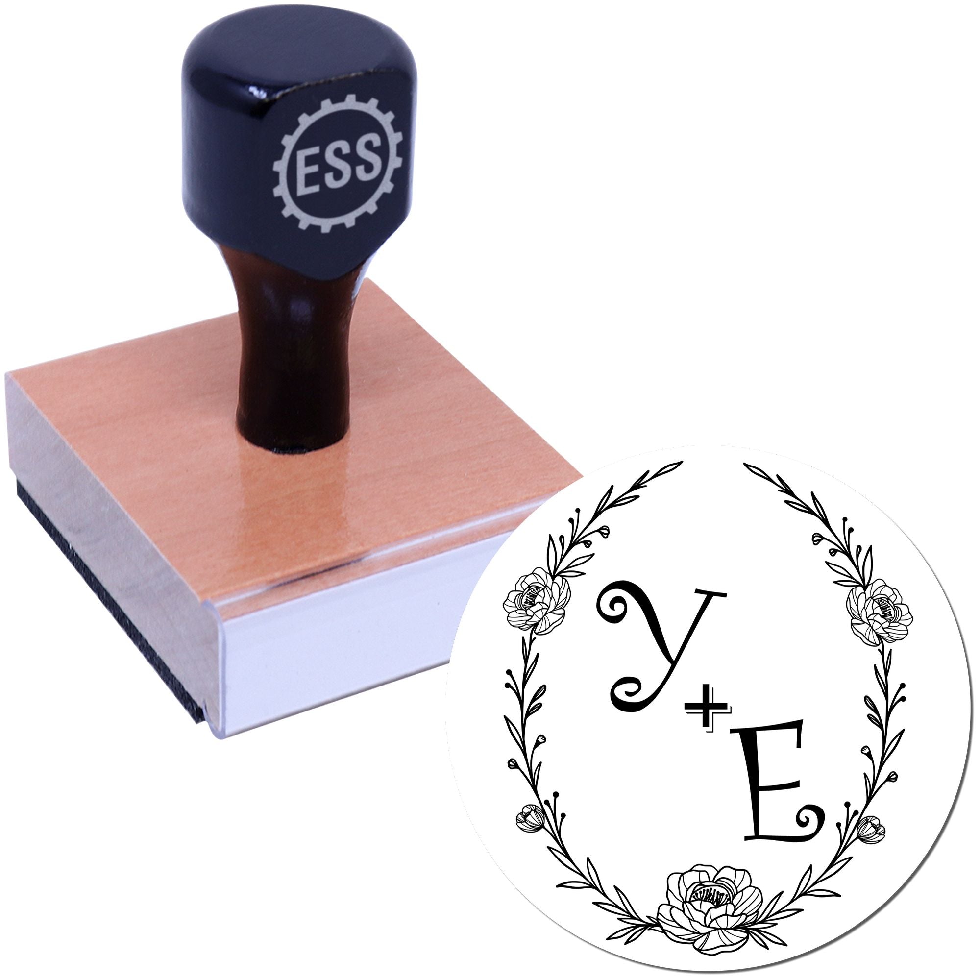 Navy rubber stamp on wooden block with custom floral seal design and initials Y and E.