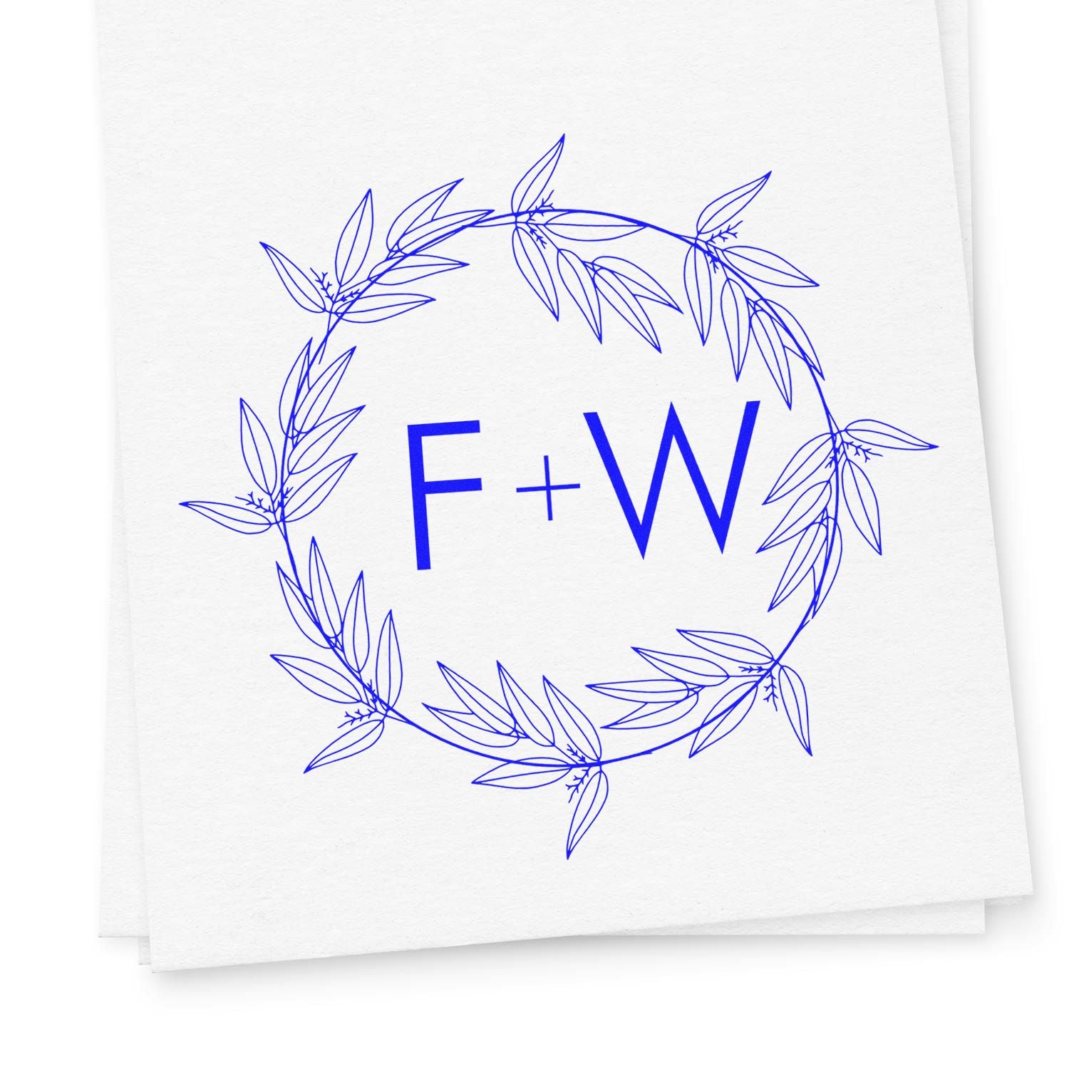 Blue F+W monogram stamp seal with leafy wreath in vivid blue on white paper.