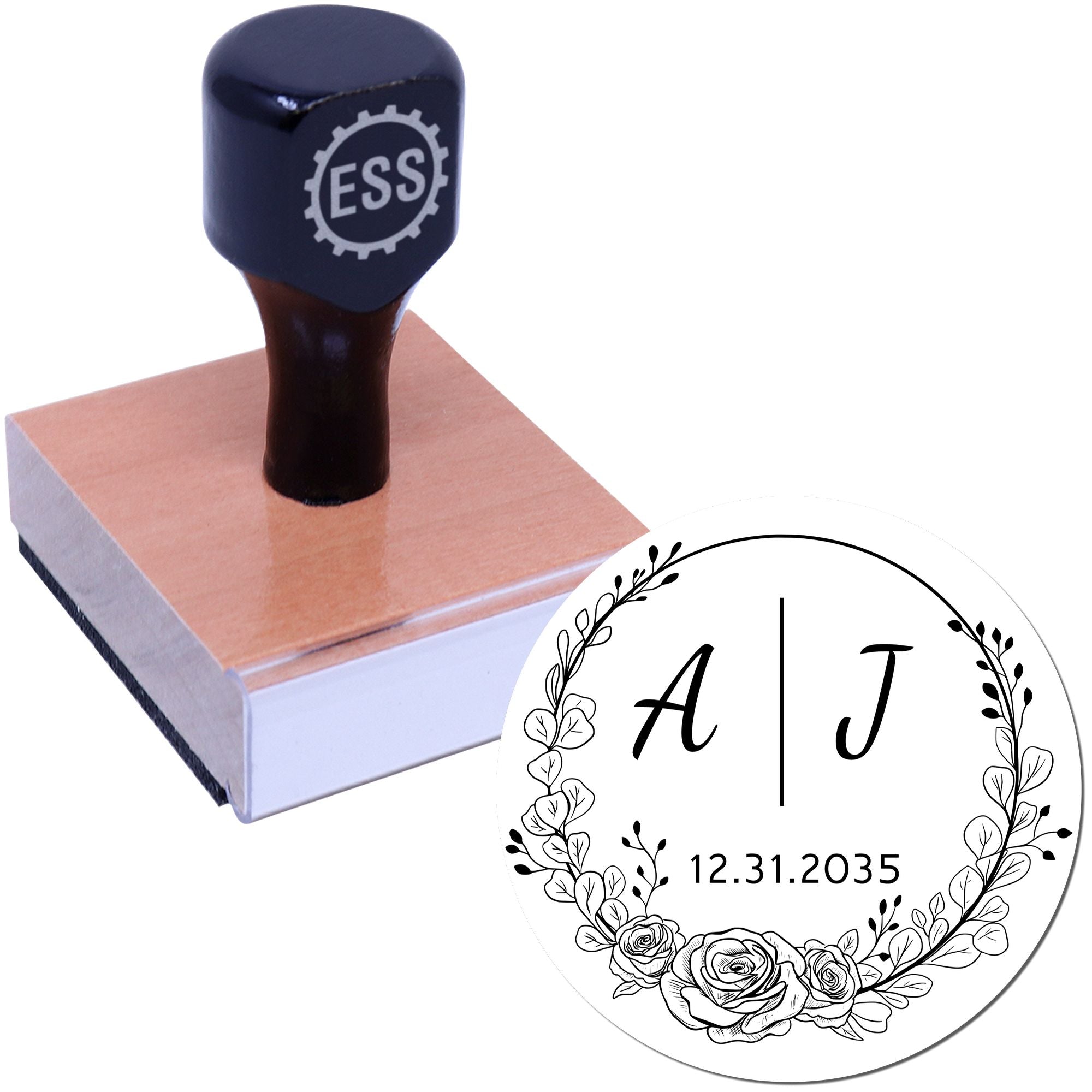 Black ESS stamp on wooden base beside white floral seal with initials A and J, floral wreath, and date 12.31.2035.