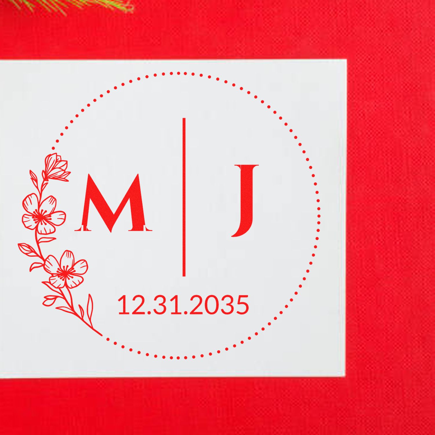 Red floral monogram stamp seal with initials M and J and date 12.31.2035 on white square background.