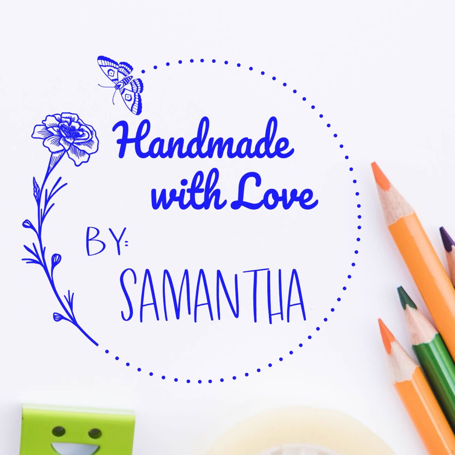 Blue handmade stamp seal reading Handmade with Love by Samantha, with butterfly, flower, and dotted circular border.