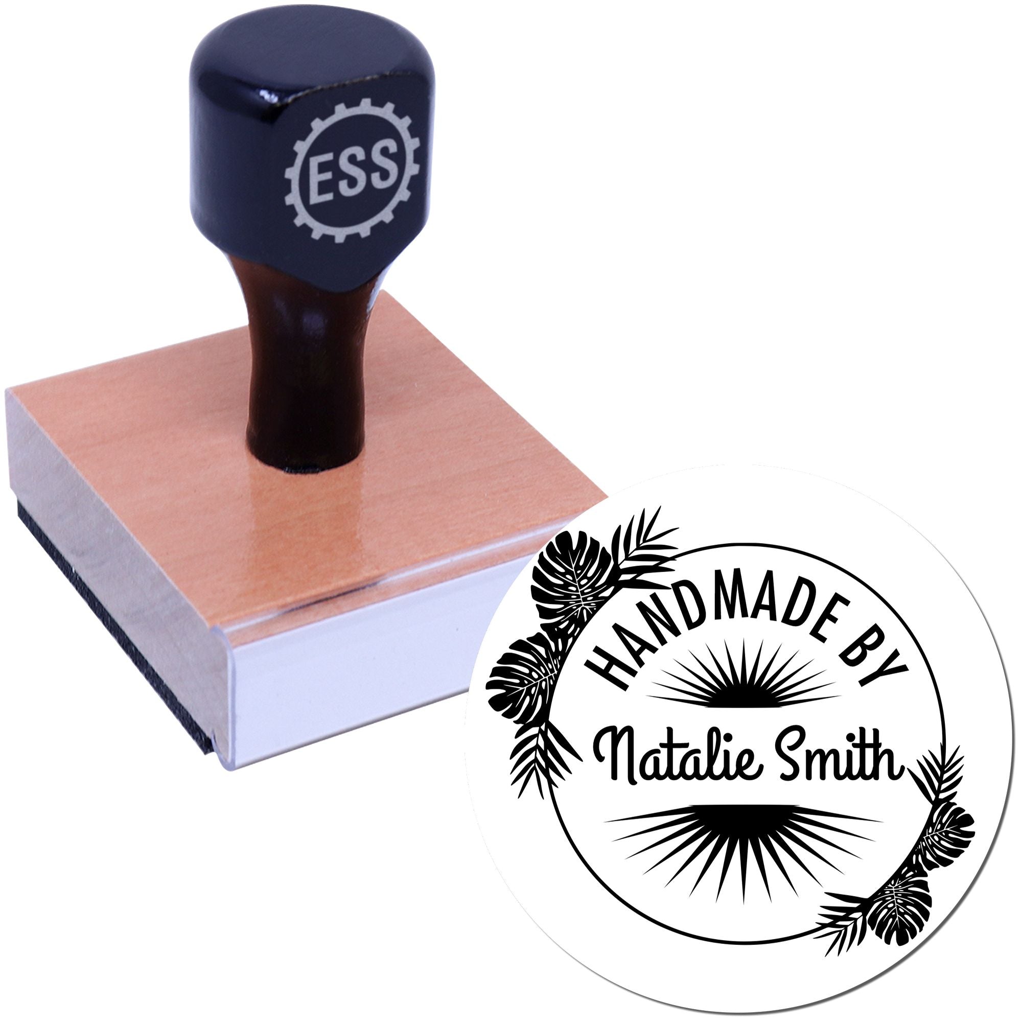 Black custom stamp on a wooden block with circular handmade seal, tropical leaves, and HANDMADE BY Natalie Smith text.