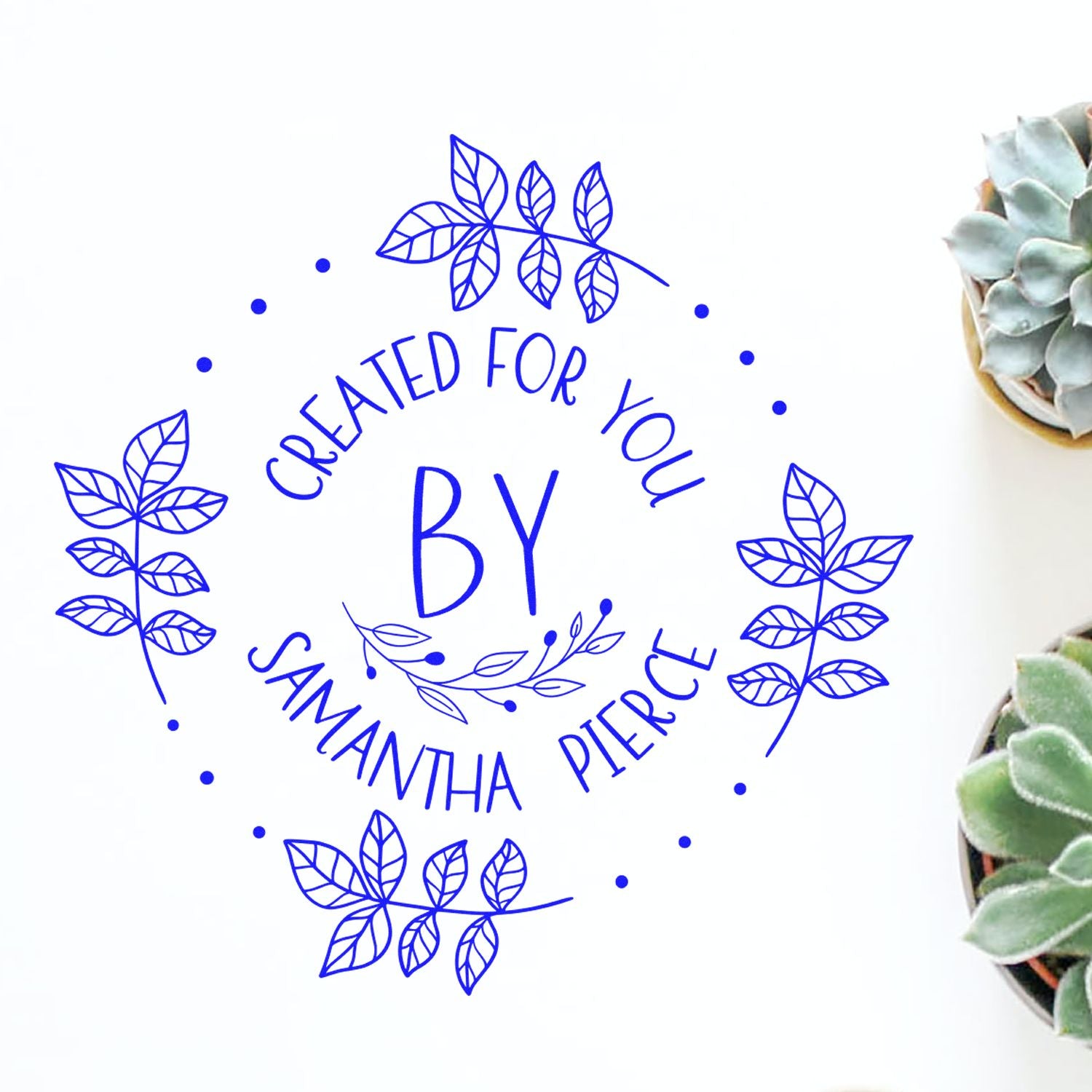 Blue botanical stamp seal reading Created for You by Samantha Pierce, with leaf wreath and succulent accents.