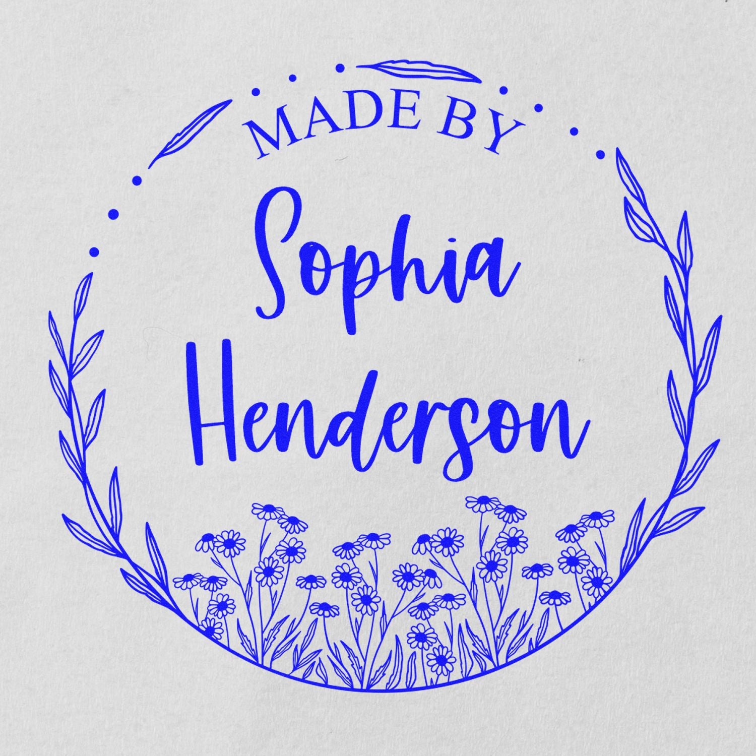 Blue circular floral stamp seal reading Made by Sophia Henderson on white paper.