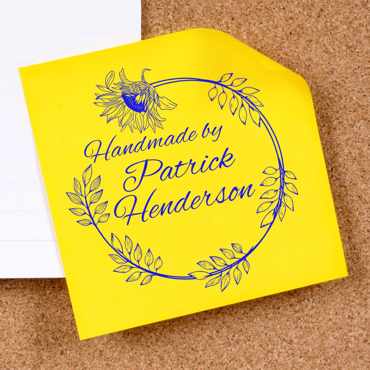 Yellow custom stamp seal with blue floral wreath and handwritten Handmade by Patrick Henderson text