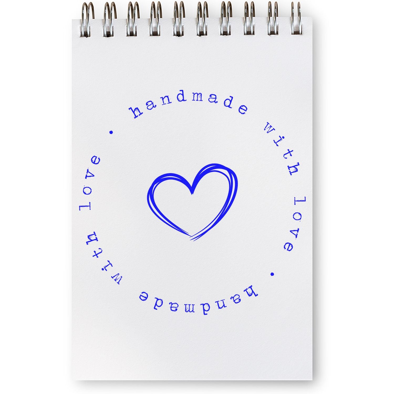 Blue handmade with love heart stamp seal on a white spiral notebook page