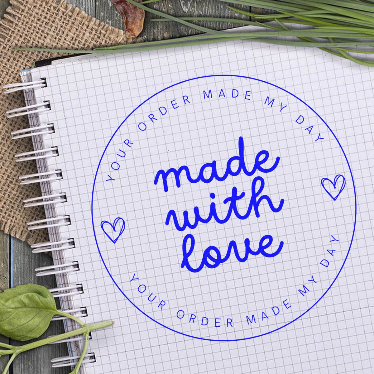 Blue circular custom stamp seal with “made with love” on grid paper, with hearts and “Your Order Made My Day” text.