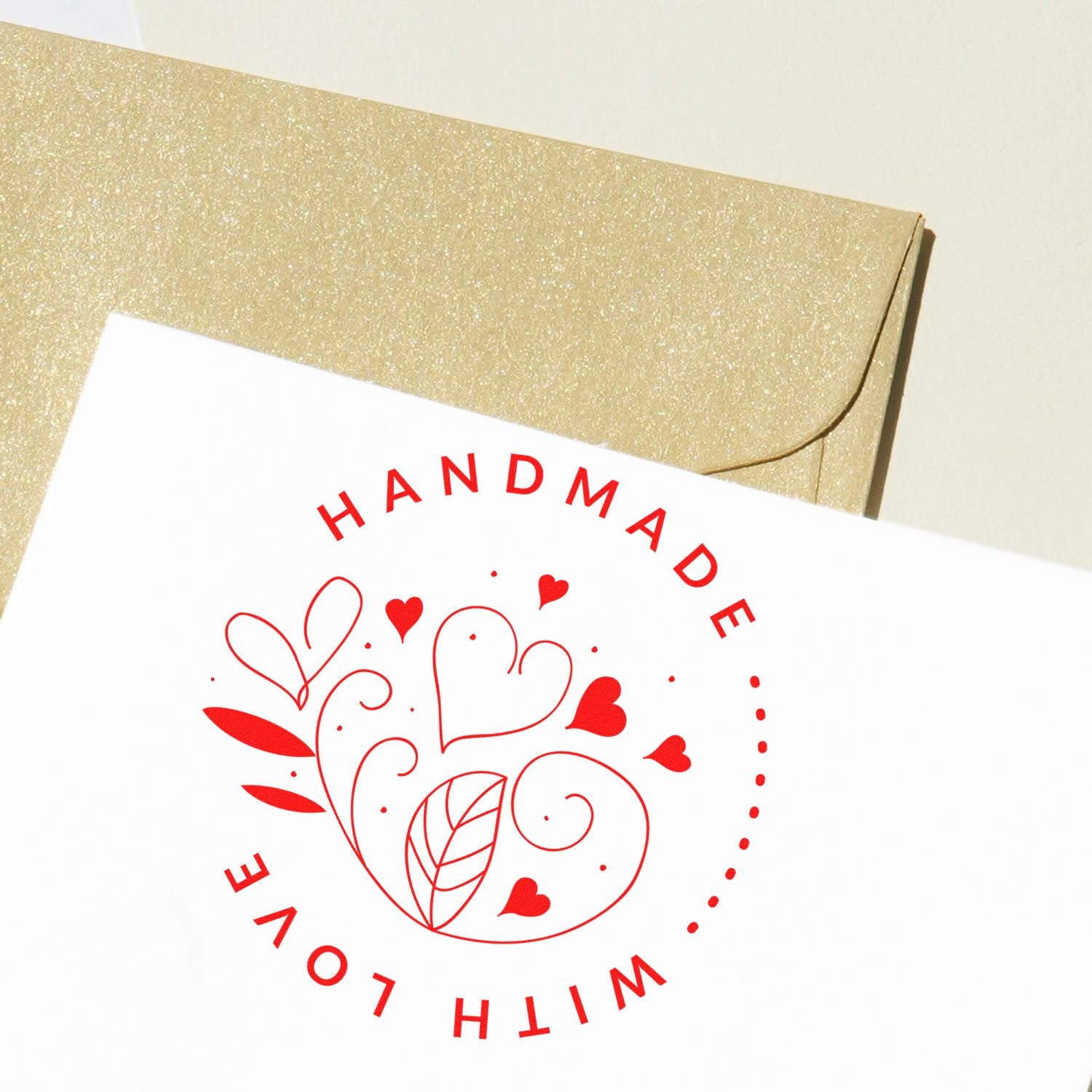 Red Handmade with Love custom stamp and seal on white card over a gold glitter envelope