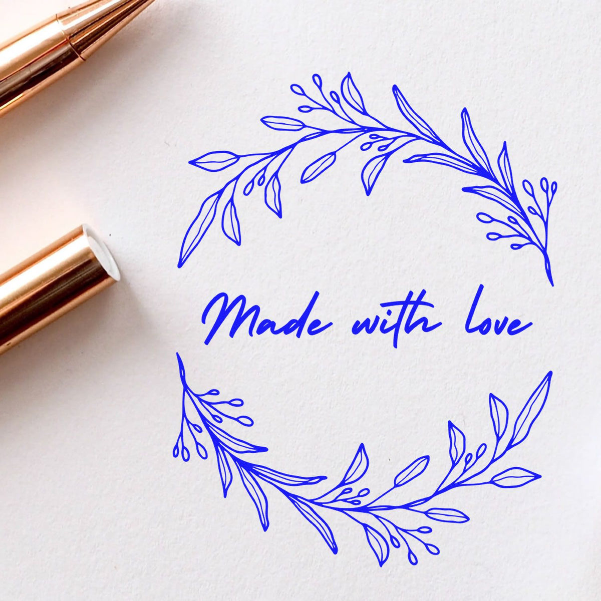 Handmade round Love's Embrace stamp by ESS in use, showcasing intricate personalized design on a stamping surface.