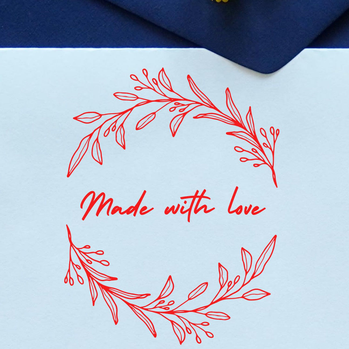 Handmade round Love's Embrace stamp by ESS in use, showcasing intricate custom design on a stamping surface.