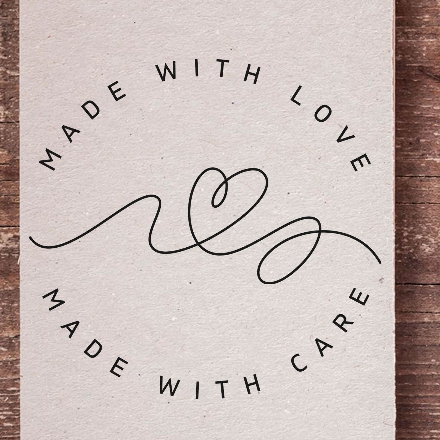 Cream stamp seal card with black Made with Love circle text and flowing heart line on rustic wood.