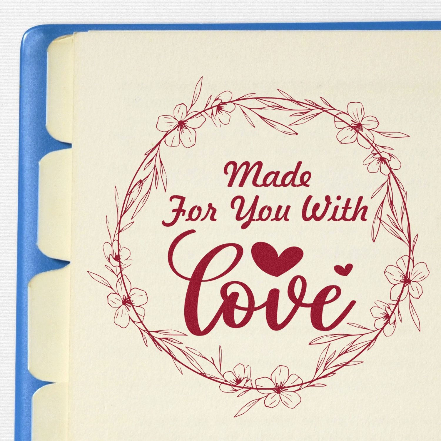 Burgundy floral stamp seal reading Made For You With Love on cream paper with blue backing.