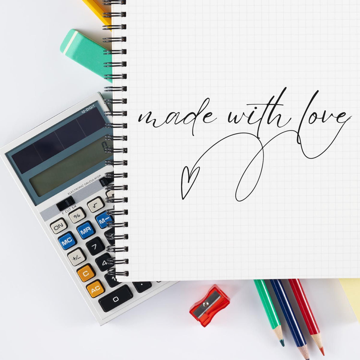 Notebook with "made with love," calculator, pencils, and stamp-and-seal office supplies in teal, red, yellow, and black.