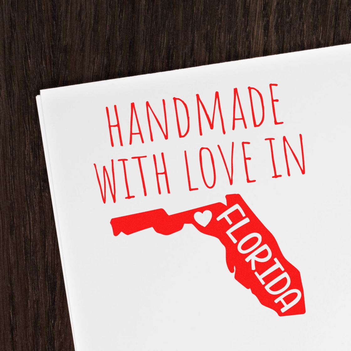 Wood Handle Florida Handmade with Love Rubber Stamp on white paper, featuring a red Florida state outline with Handmade with Love in Florida text. Perfect for crafts and personalized projects.