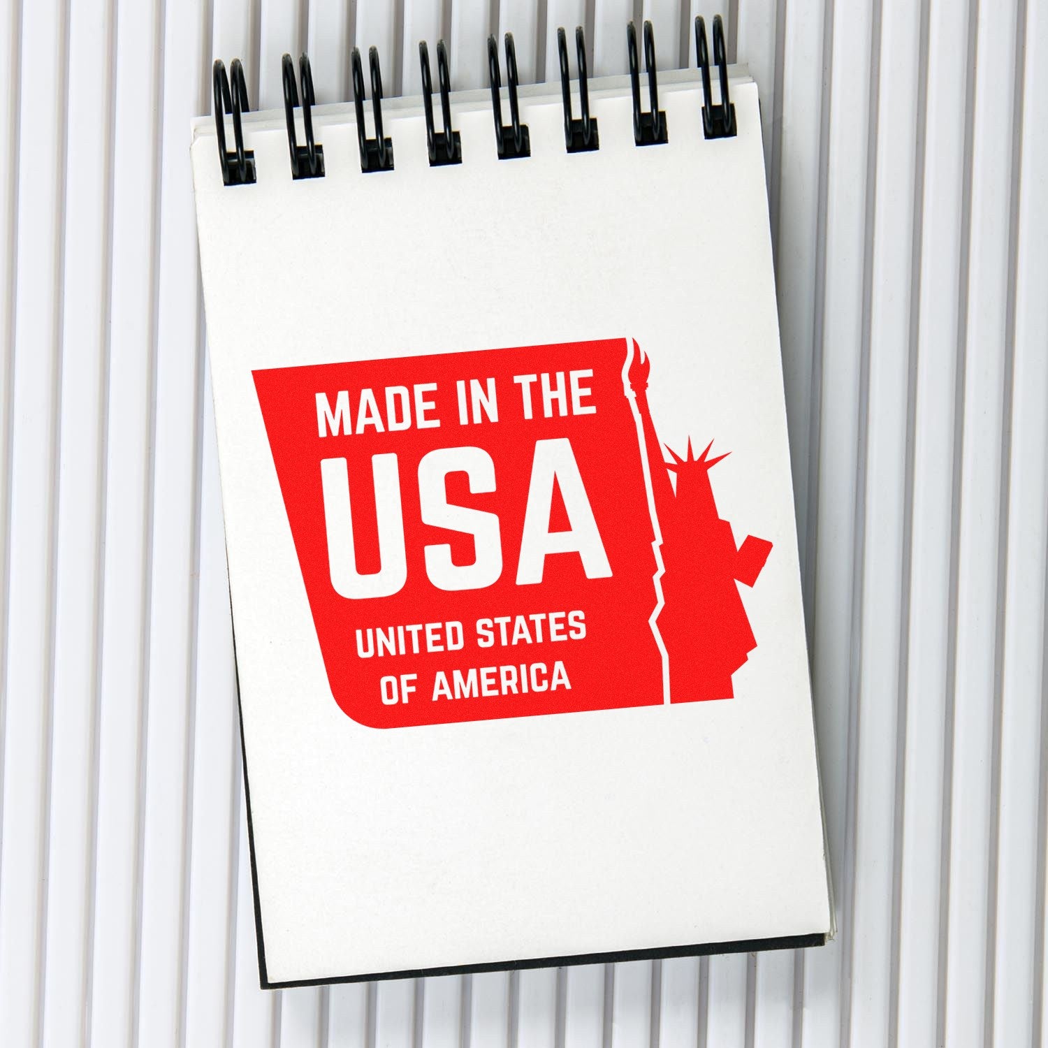 Liberty Made USA rubber stamp with wooden handle and ESS branding, in use for stamping on paper or craft projects.
