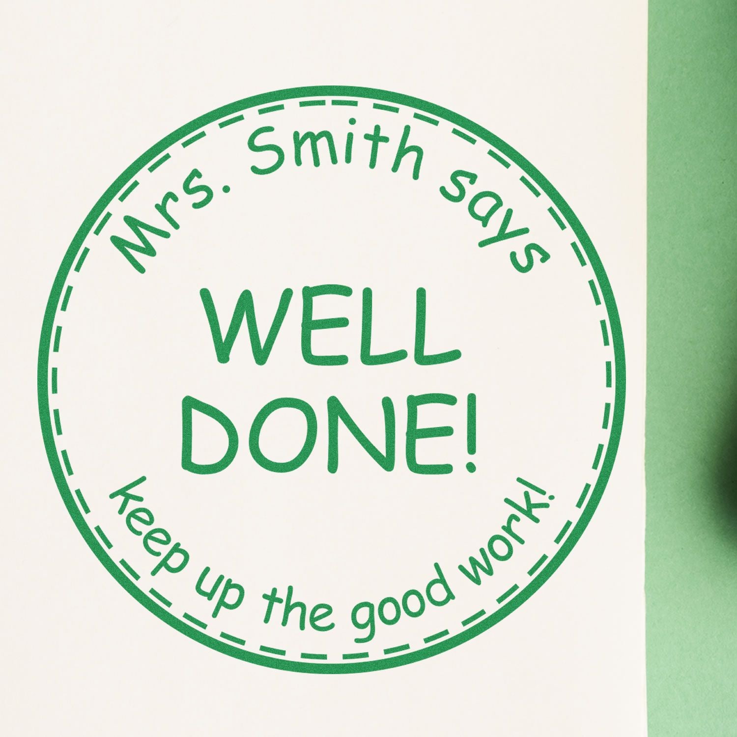 Green circular self-inking stamp seal reading Mrs. Smith says WELL DONE! Keep up the good work! on white background.