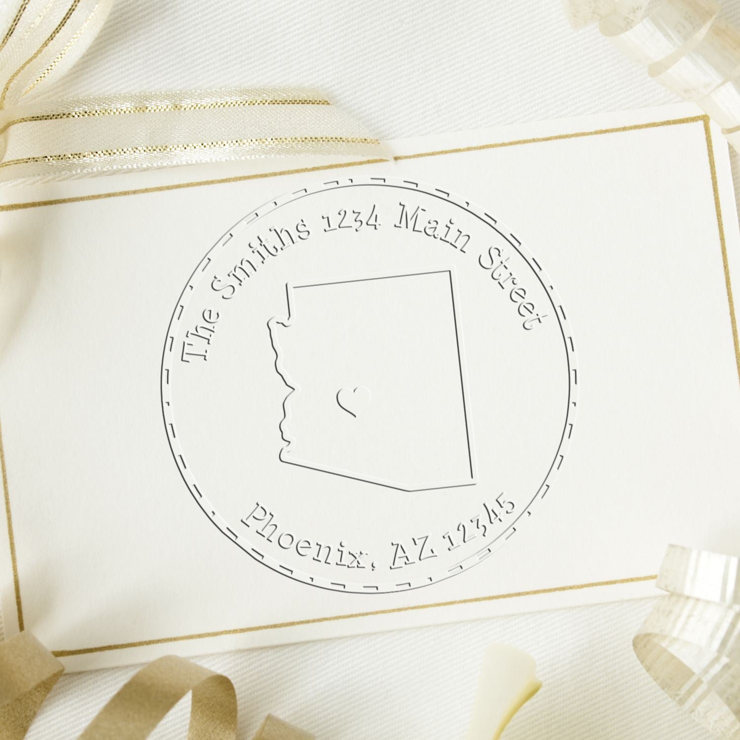 White and gold embossed custom stamp seal with circular Arizona address design, state outline, and ribbon accents