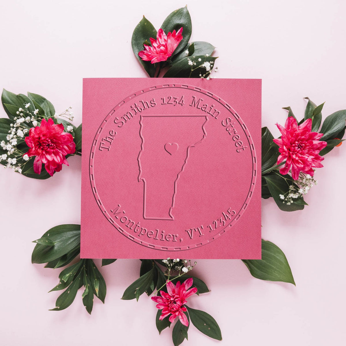 Pink custom stamp and seal card with embossed Vermont outline, circular text, and bright pink flowers with green leaves