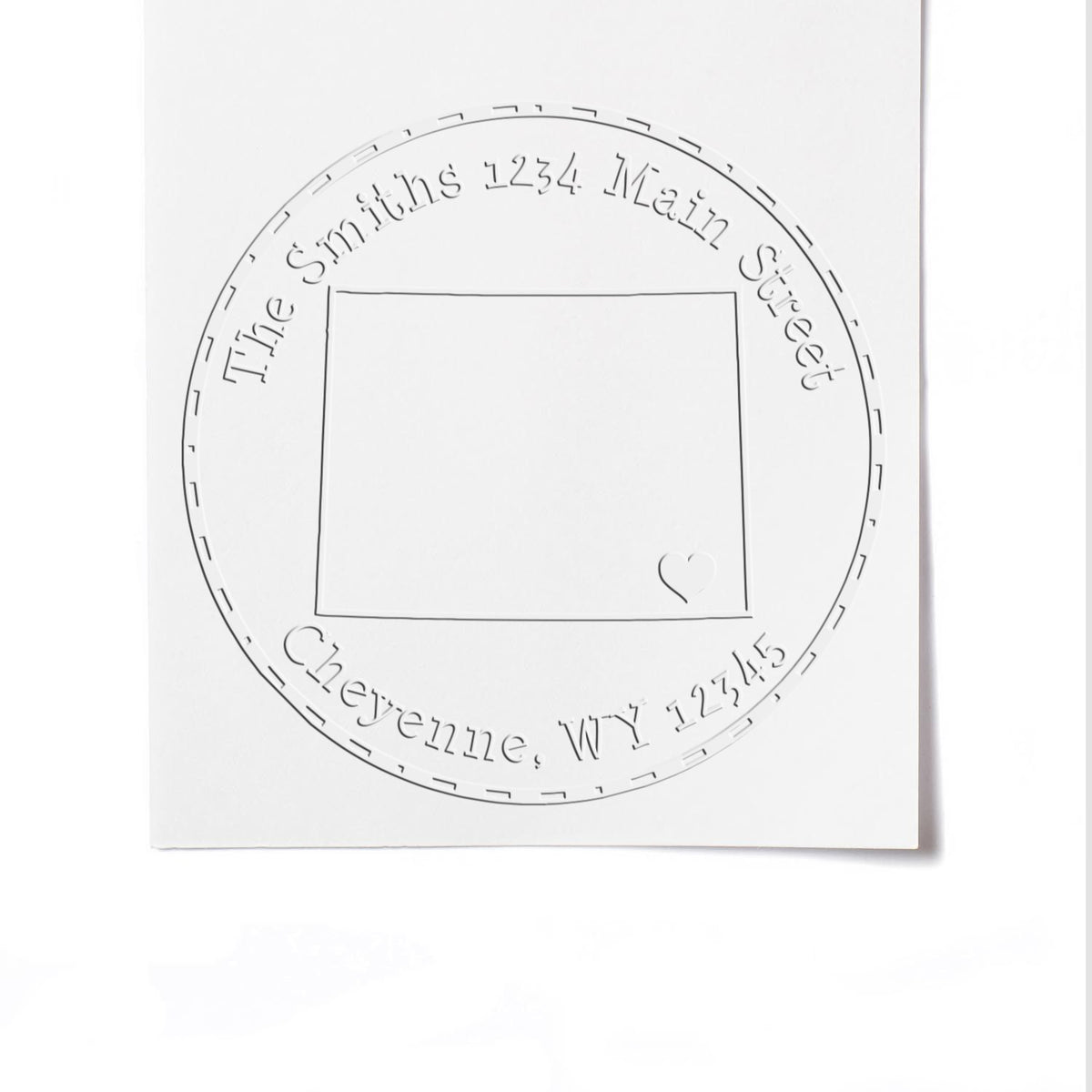 White custom address stamp seal with circular embossed text, square center, and small heart accent.
