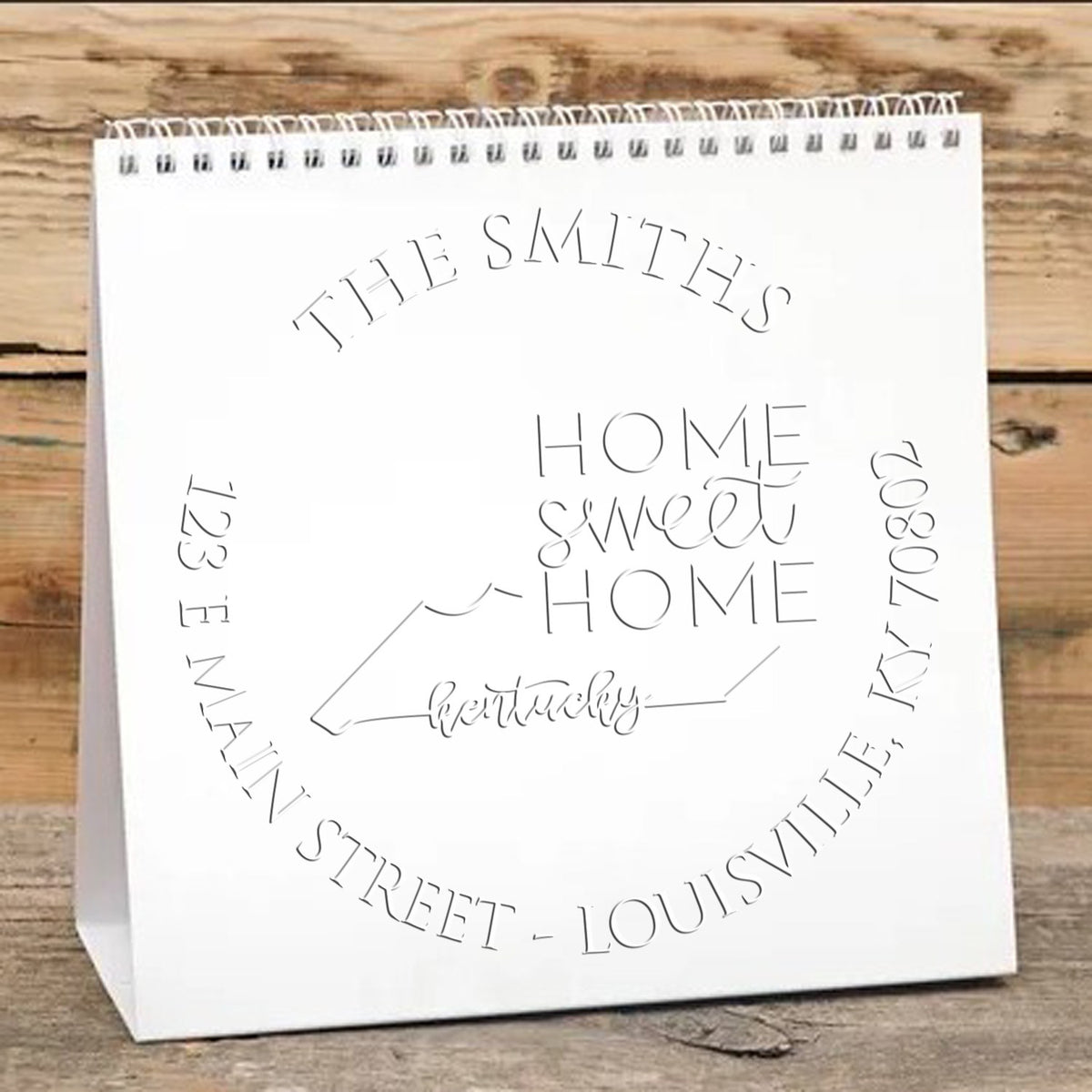 Shiny Round KY Soft Personalized Return Embossing Seal with State Love Stamps in use, showcasing detailed embossing on paper.