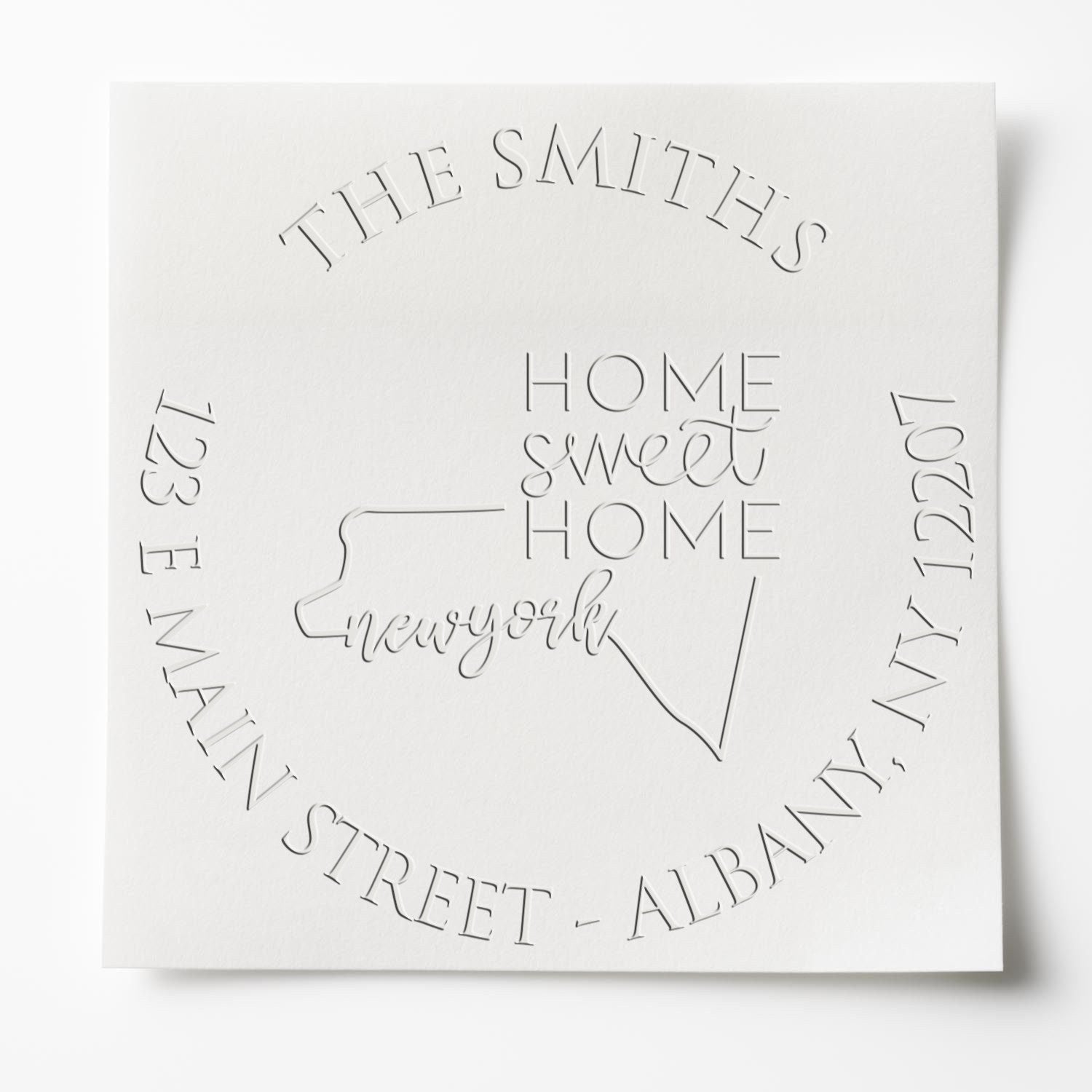 White embossed stamp seal with The Smiths, Home Sweet Home, and circular city names in raised gray lettering.