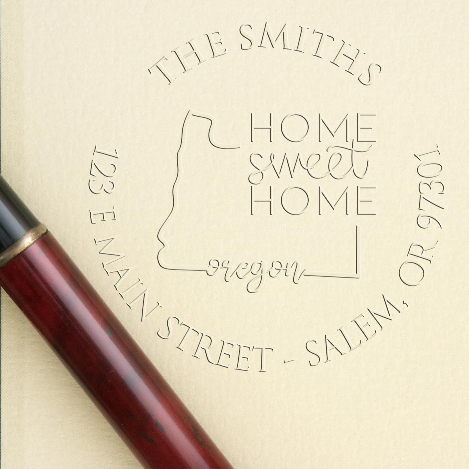 Maroon wax seal stamp on cream background with engraved Home Sweet Home and The Smiths address seal design