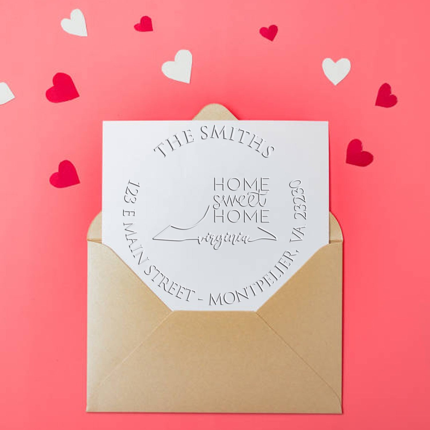 Custom white embossed stamp seal on tan envelope, with pink background and red-and-white heart confetti.
