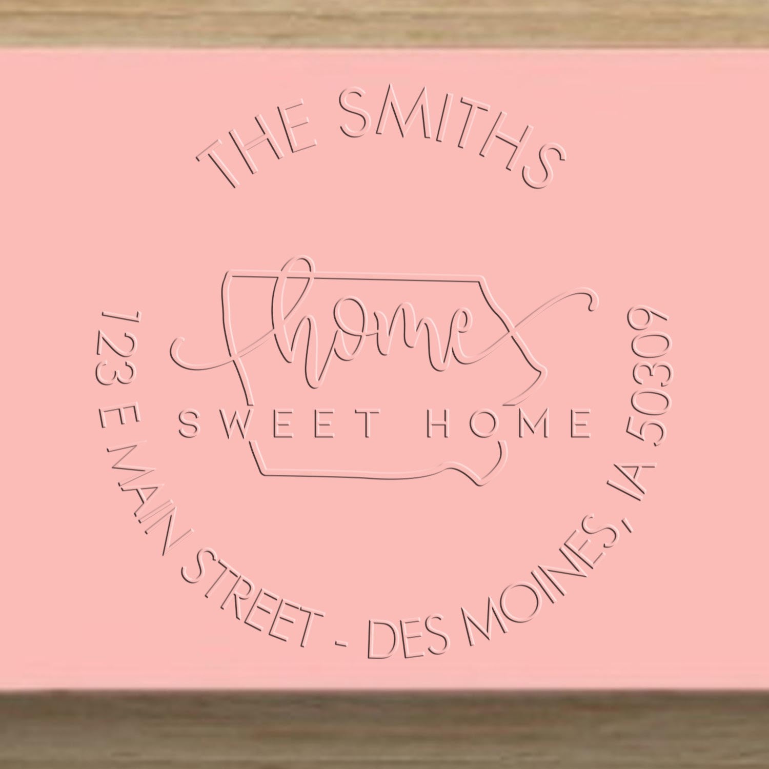 Pink embossed stamp and seal reading The Smiths Home Sweet Home with 123 Main Street, Des Moines, IA 50309.
