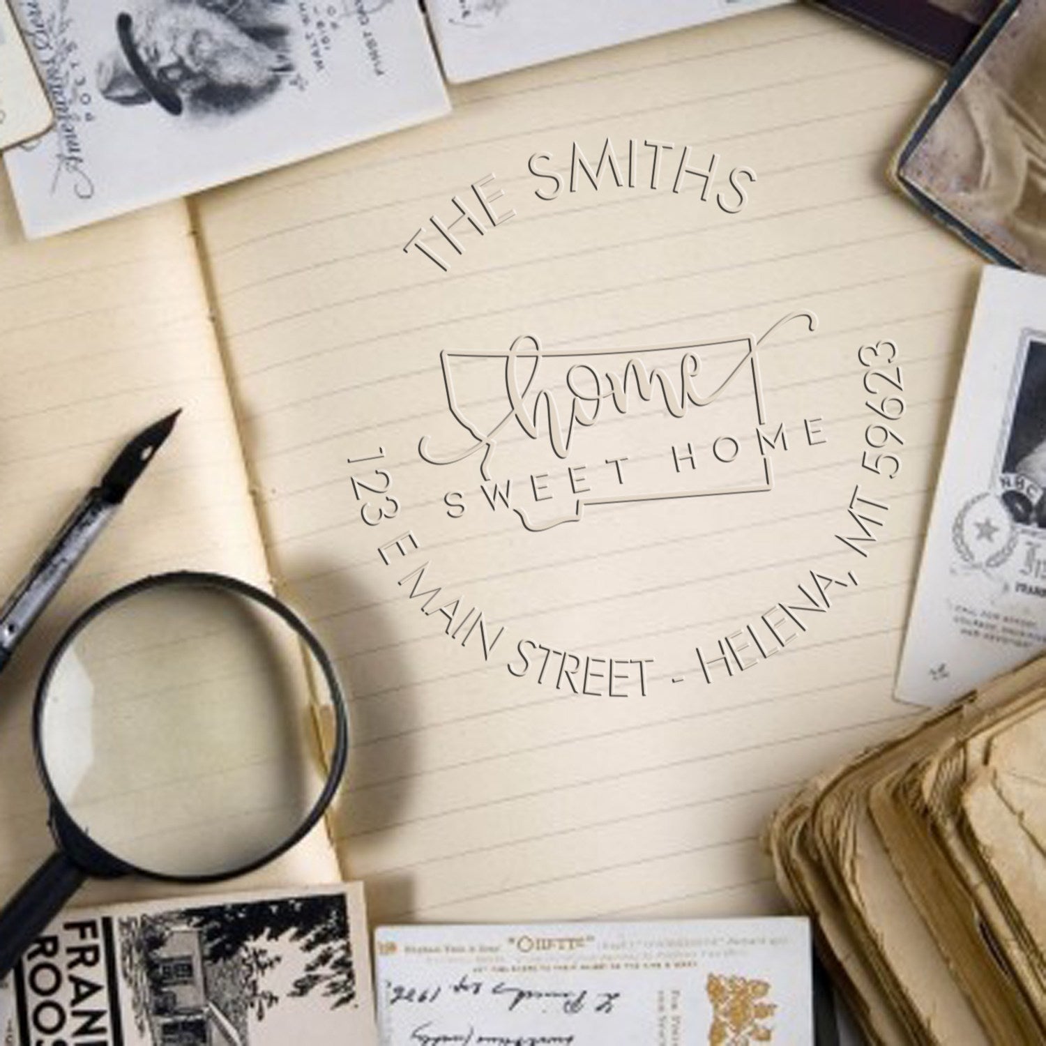 Cream lined notebook with custom "Home Sweet Home" stamp seal, black lettering, and vintage stationery accents.