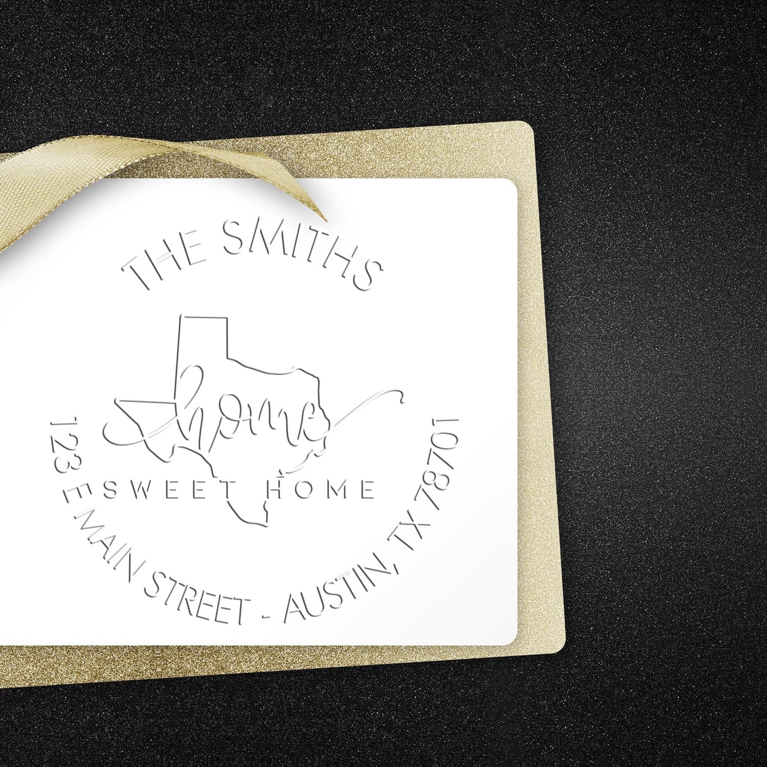 White custom stamp and seal card with gold ribbon, black glitter background, and Texas family crest design.