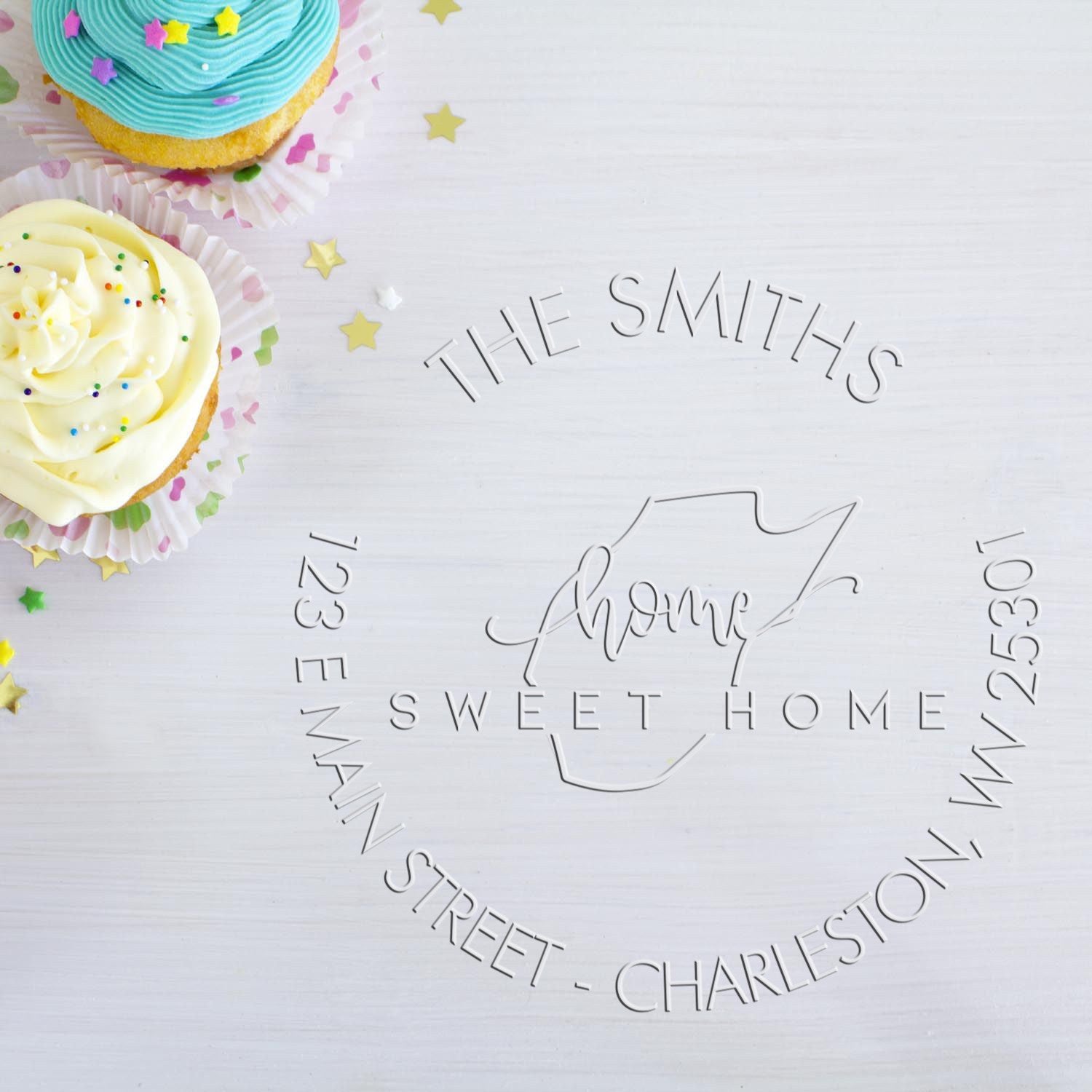 Custom silver stamp and seal with The Smiths home sweet home, beside pastel blue and cream cupcake seal samples.