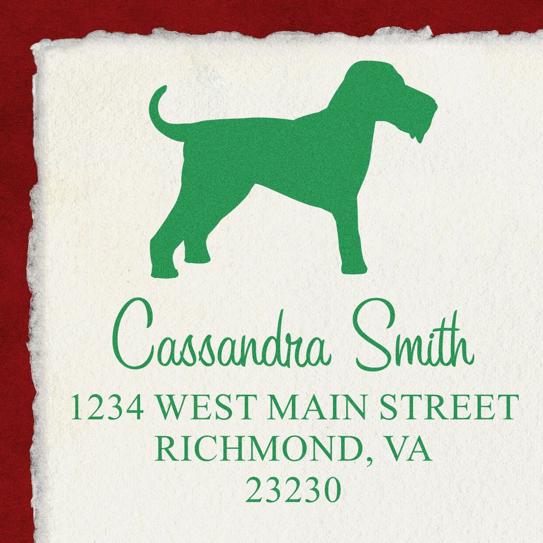 Custom return address stamp with green dog silhouette, Cassandra Smith name, on torn white paper over red background.