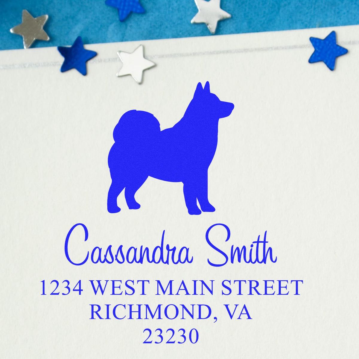 Blue custom dog stamp and seal with Cassandra Smith address, on white paper, decorated with blue, silver, and white stars.
