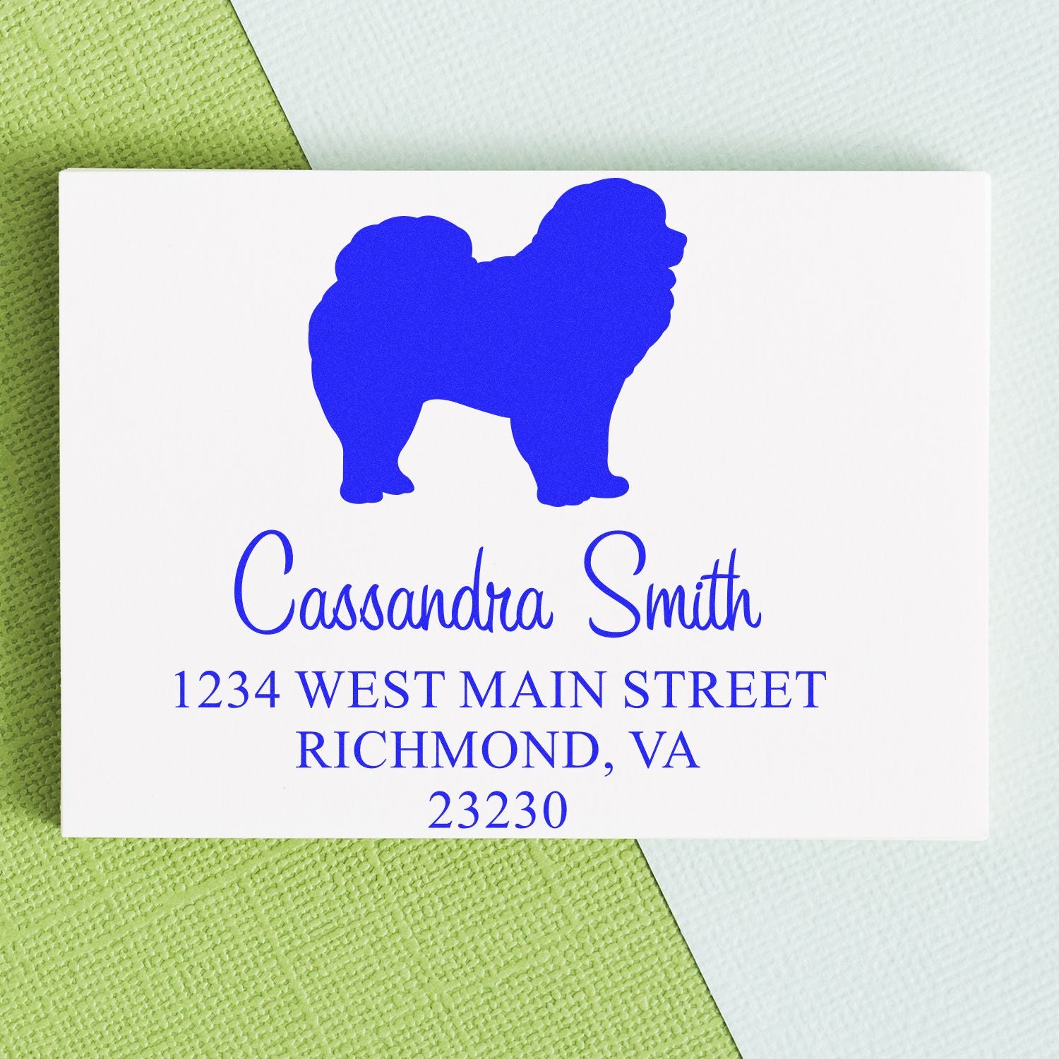 Blue dog silhouette custom address stamp with Cassandra Smith, Richmond VA, on white card over green and white background.