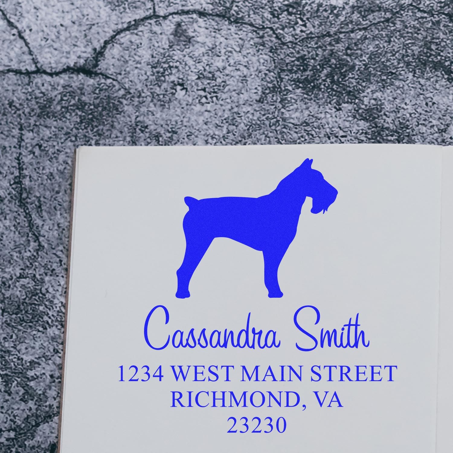 Wood handle Schnauzer dog stamp by ESS in use, showing a detailed rubber address label stamp featuring a Schnauzer illustration.