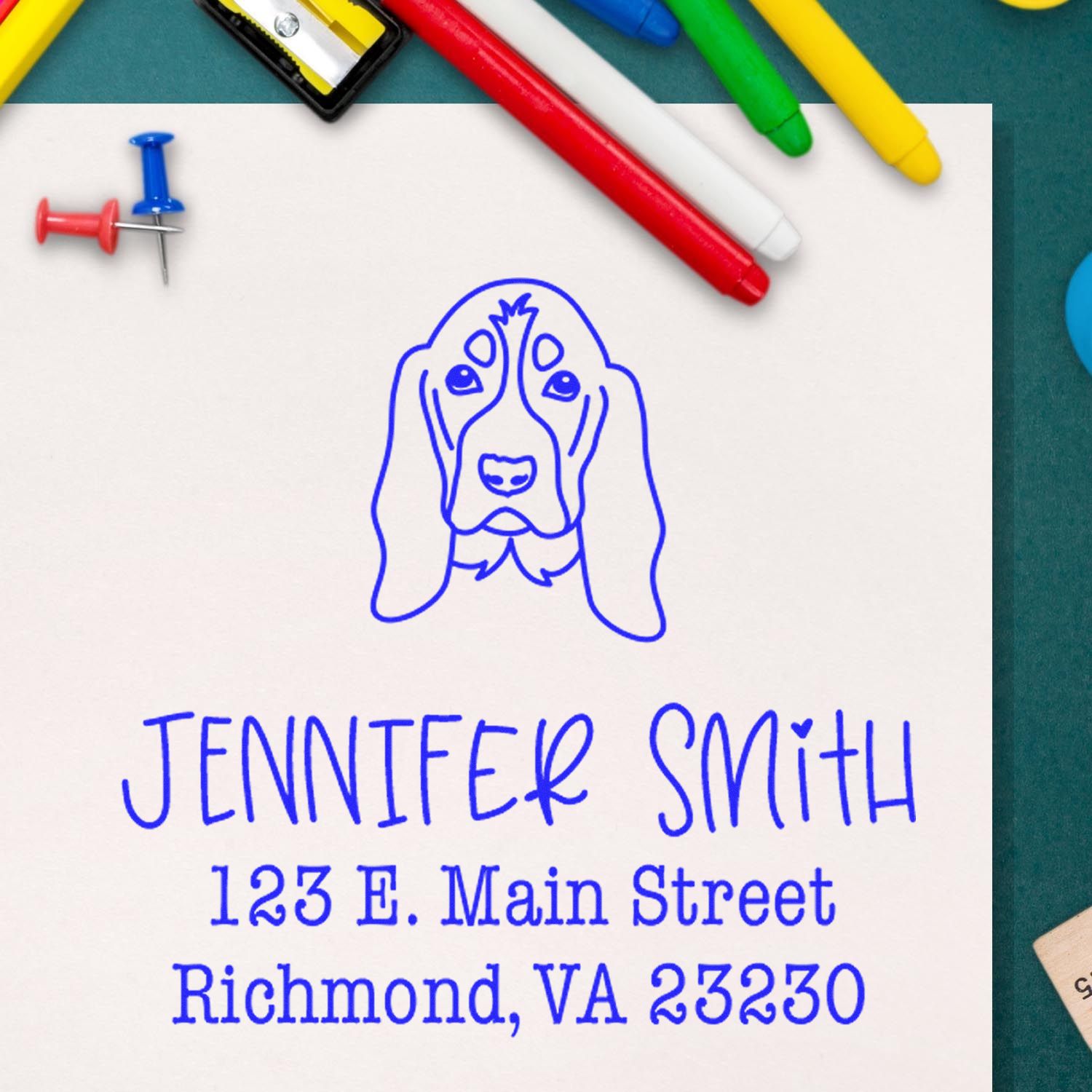 Blue custom address stamp and seal with dog logo, Jennifer Smith, and Richmond, VA address, beside colorful markers and pins.