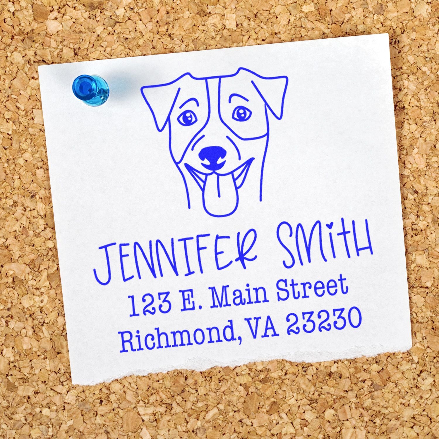 Blue custom stamp and seal with dog logo, Jennifer Smith address, pinned to corkboard with a blue pushpin.