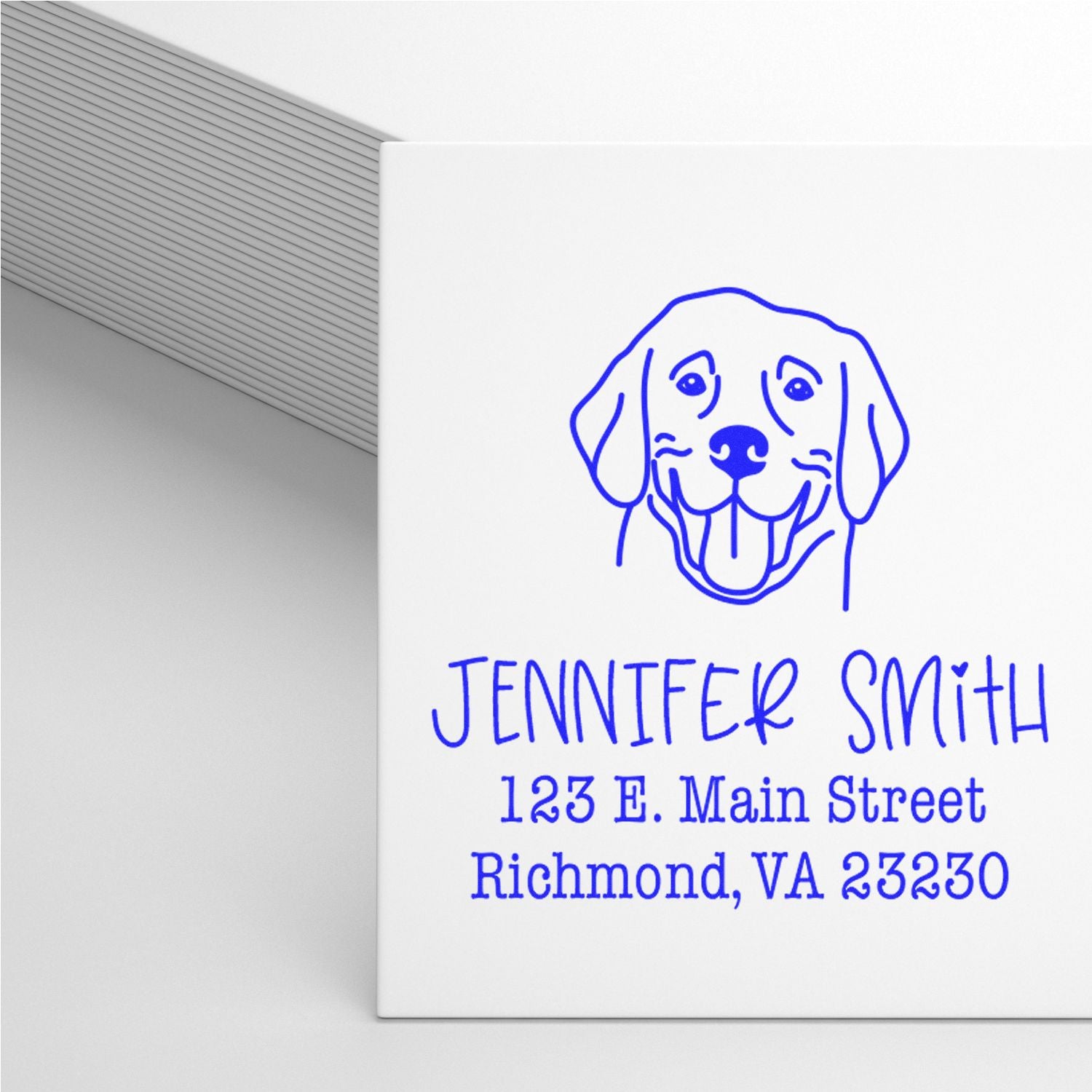 Blue dog logo self-inking address stamp and seal with Jennifer Smith, 123 E. Main Street, Richmond, VA 23230 on white.