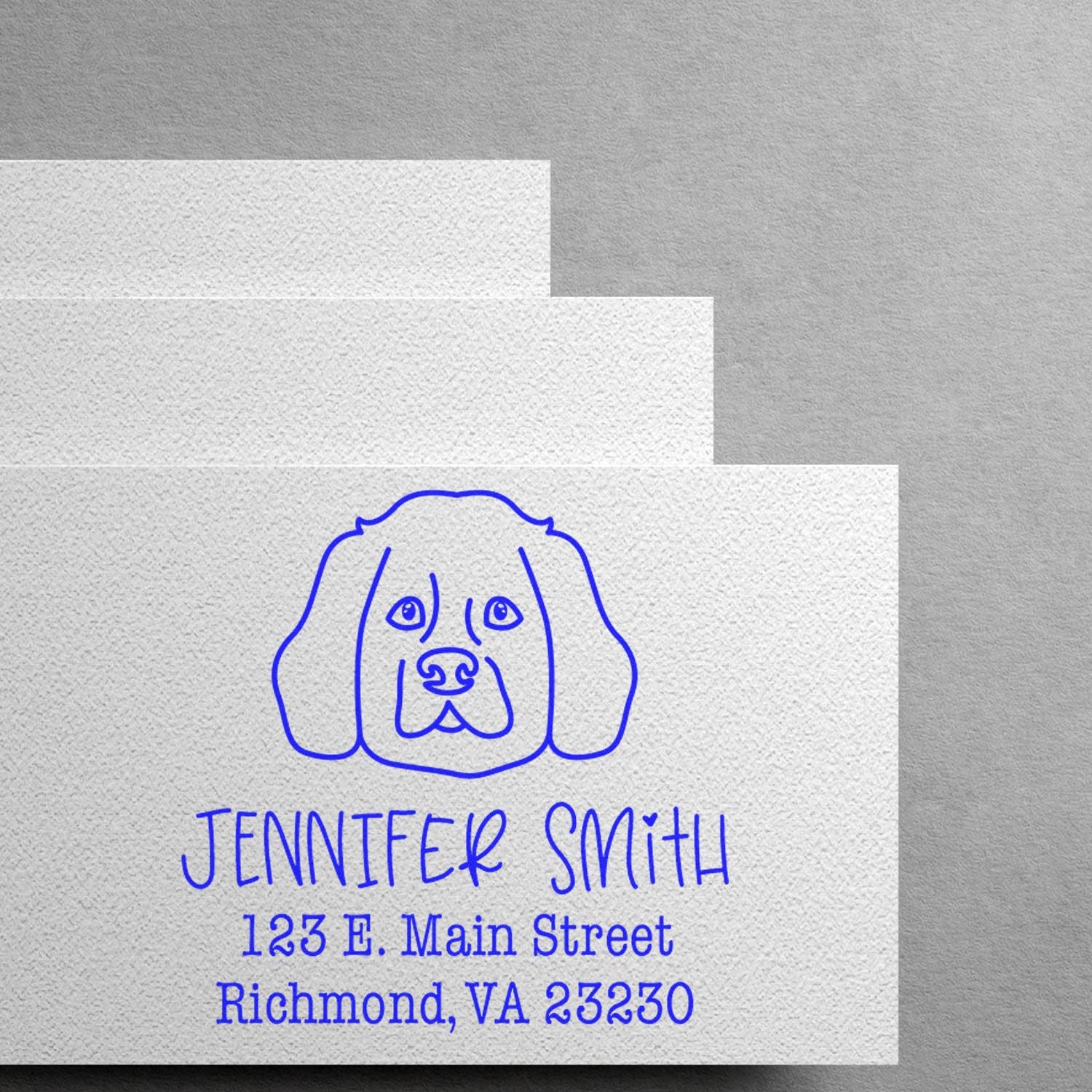 Blue custom stamp and seal with dog illustration on textured white paper, reading Jennifer Smith, Richmond, VA 23230.