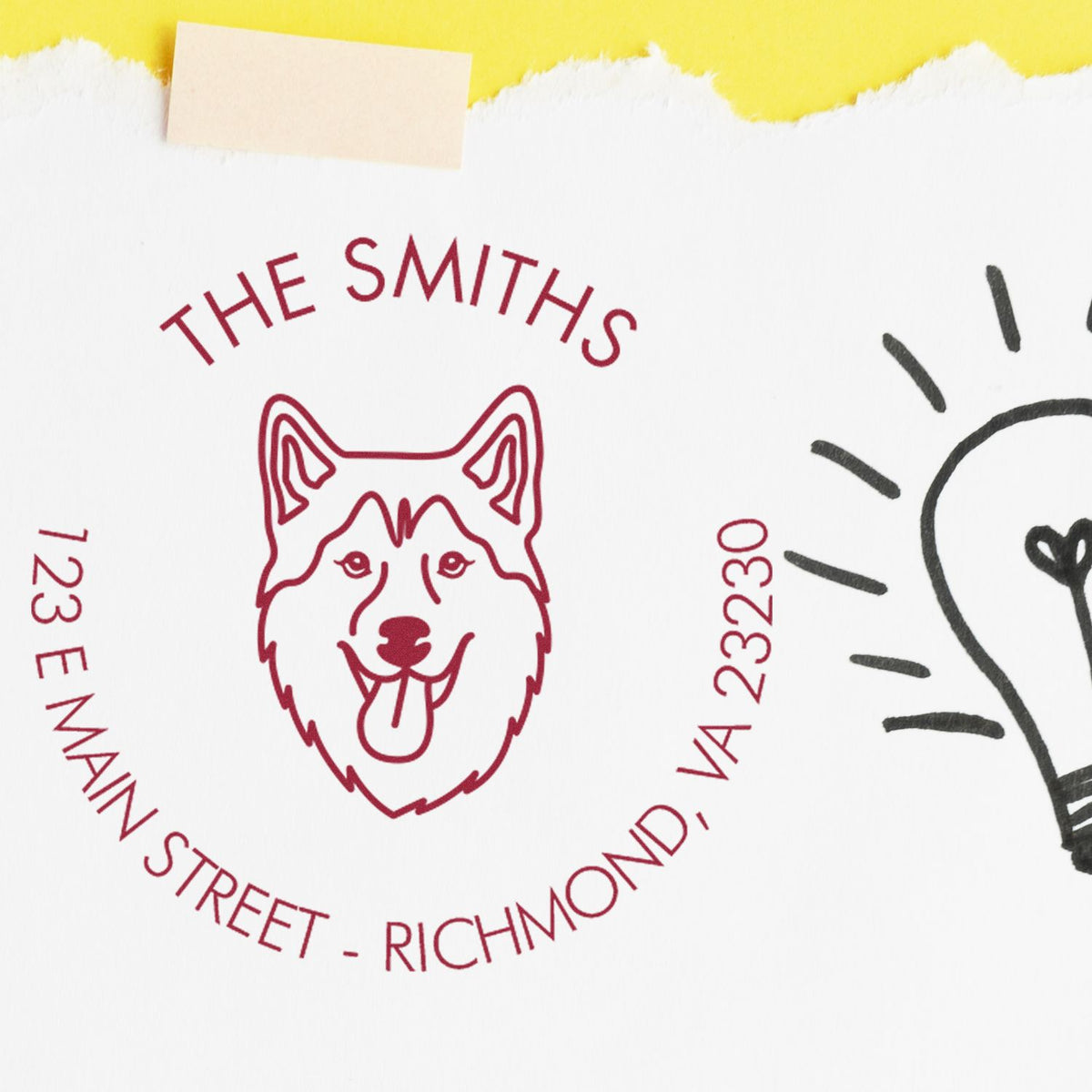 Red custom dog address stamp seal on white paper, with yellow torn edge and partial black line art.