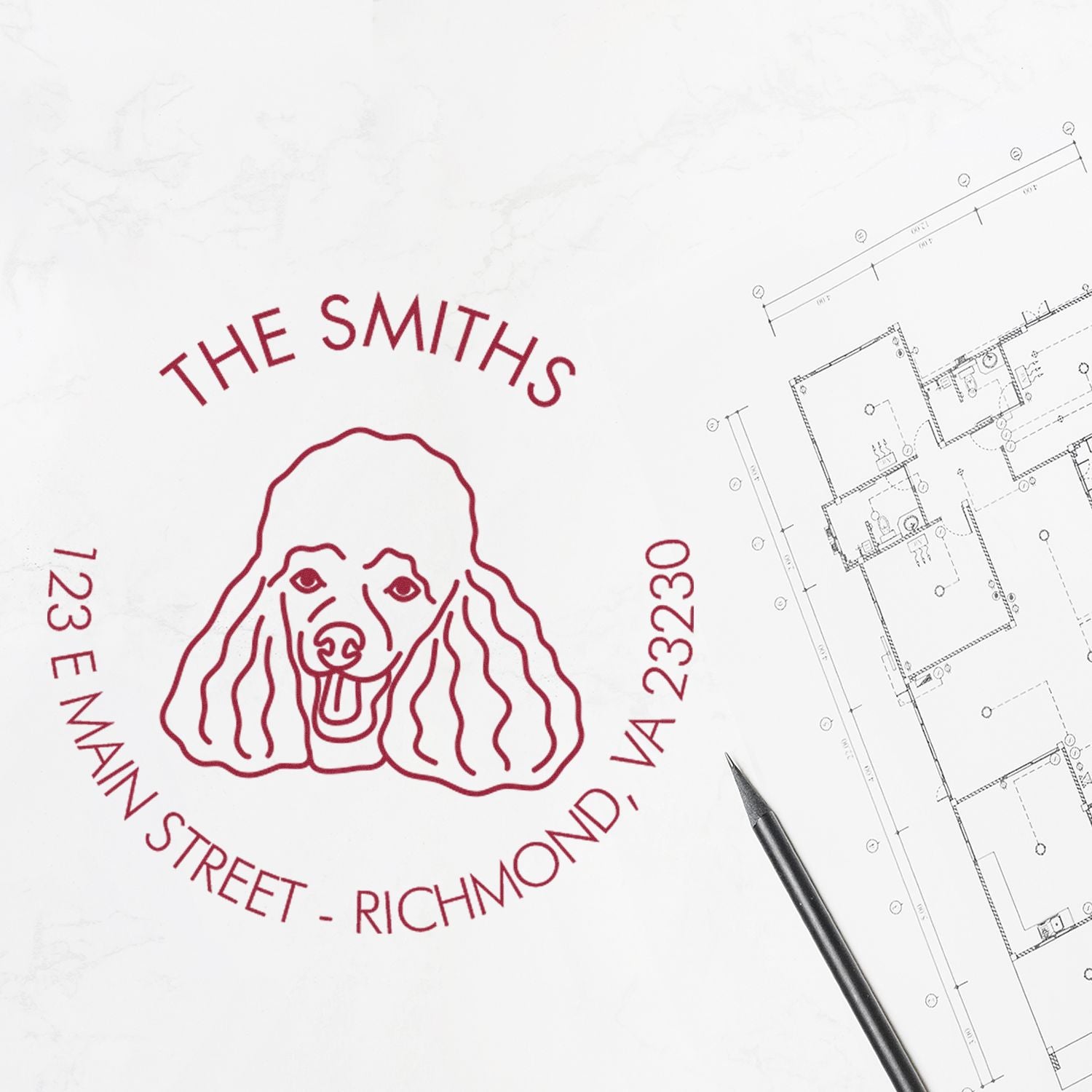 Red custom dog stamp seal for The Smiths, 123 E Main Street, Richmond, VA 23230 on white blueprint with pencil.