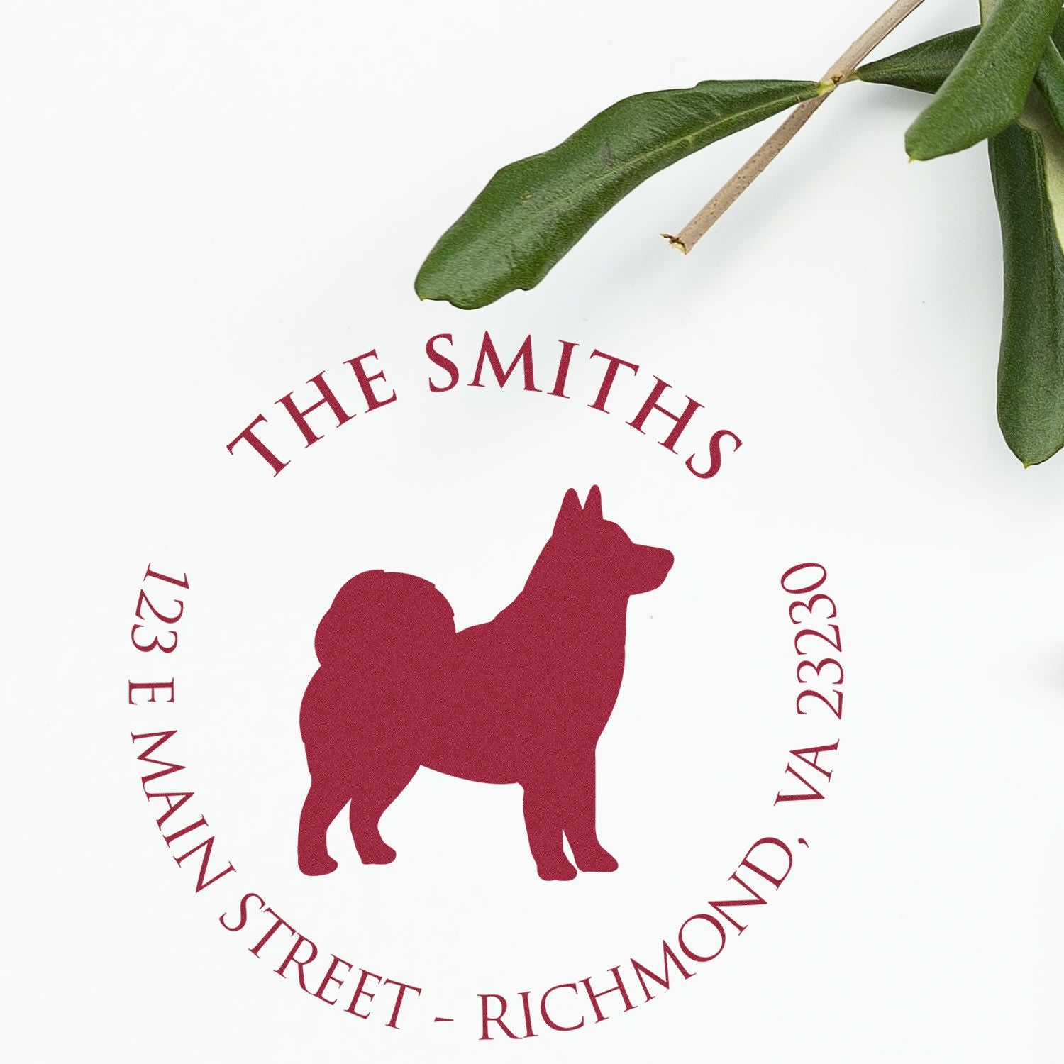 Custom red dog stamp seal for The Smiths, 123 E Main Street, Richmond, VA 23230, on white with green leaves.