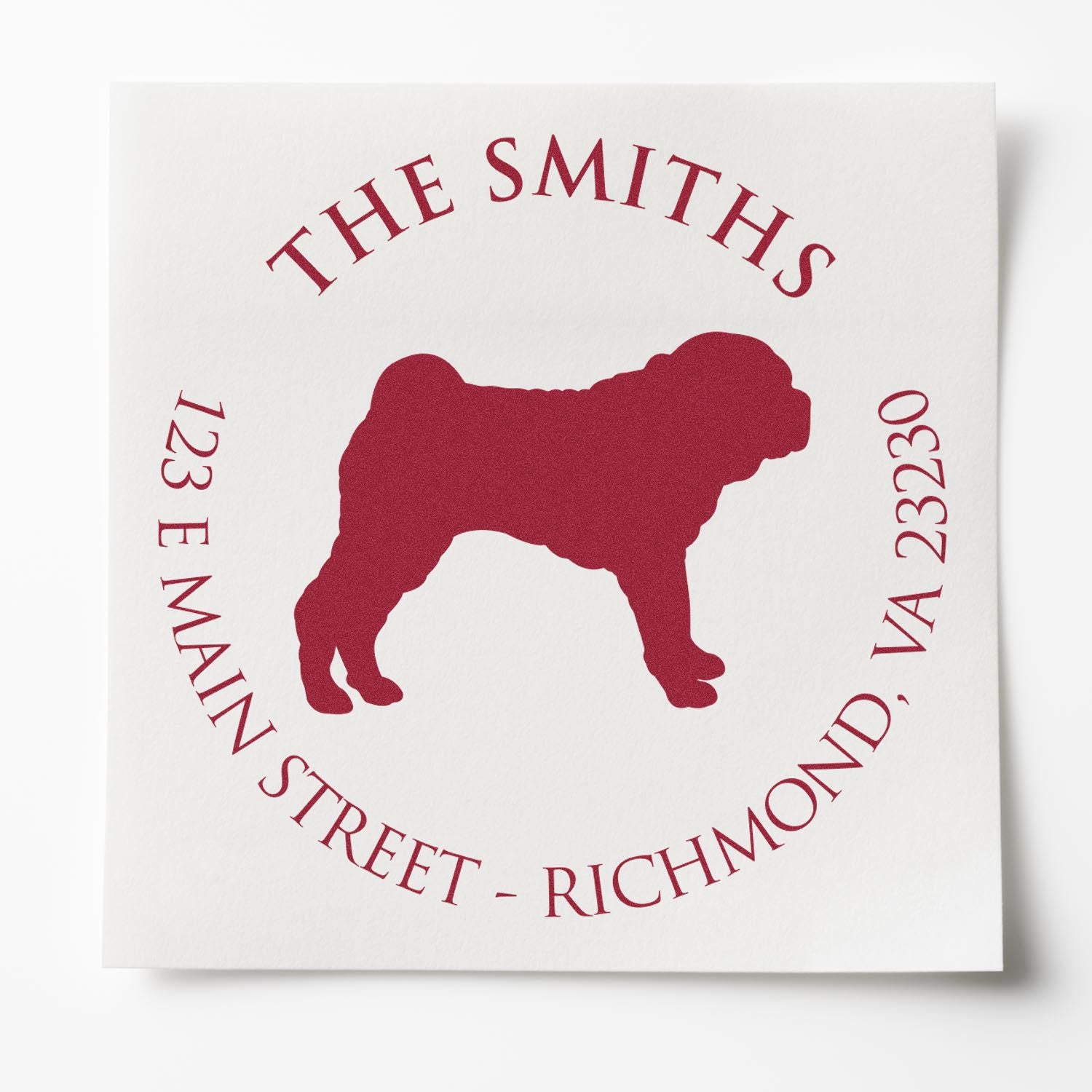 Maroon custom address stamp seal with dog silhouette, The Smiths, 123 E Main Street, Richmond, VA on white paper.